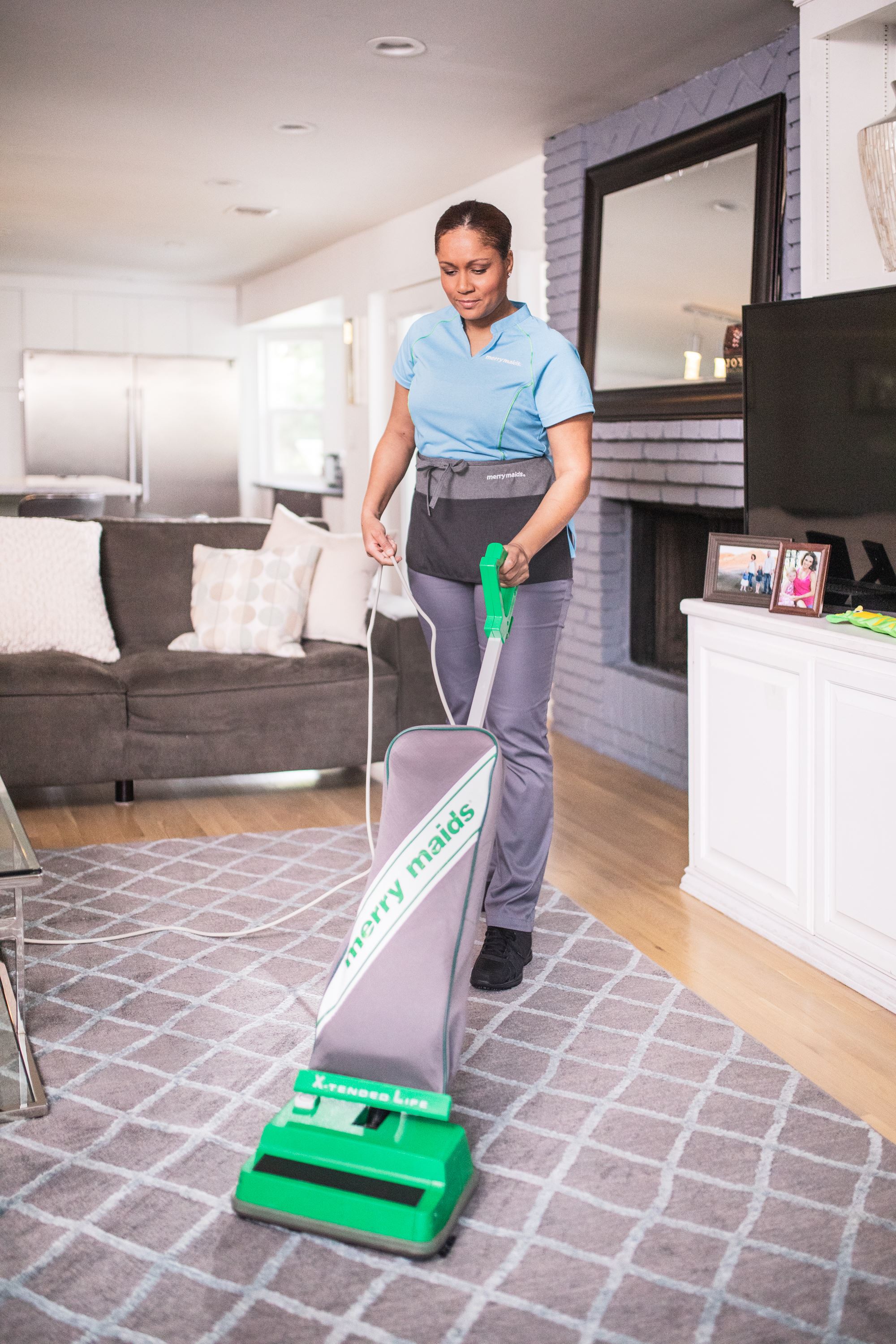 Merry Maids of Poway & Rancho Bernardo team member vacuuming during maid service