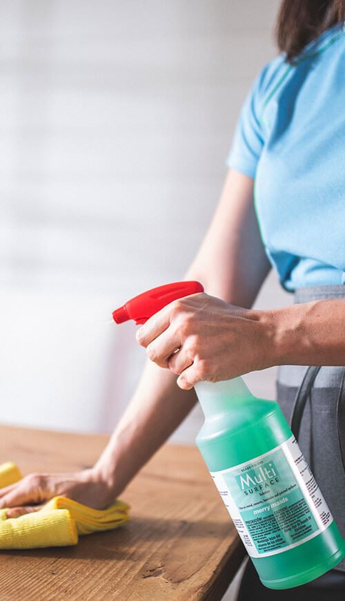 professional cleaner using a green cleaning product