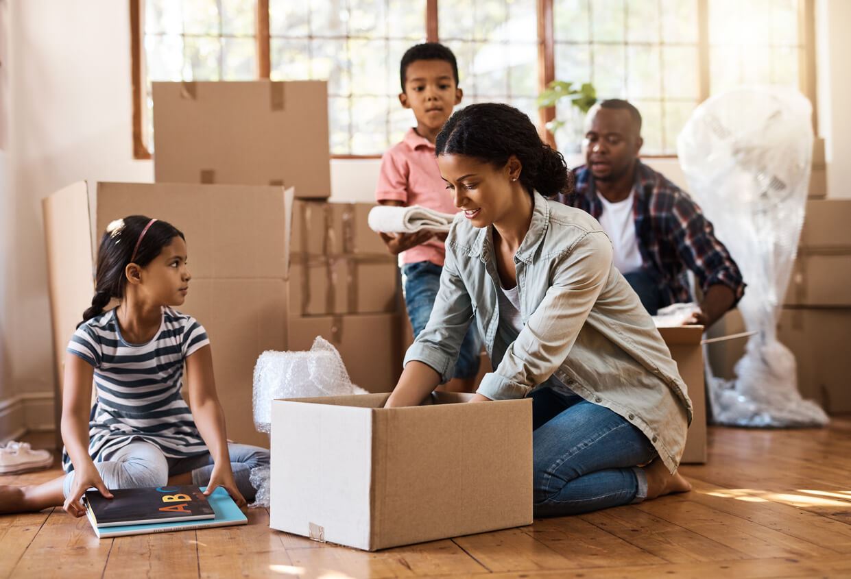 family packing boxes as they prepare to move