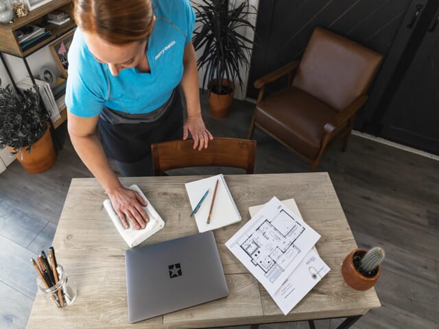 Professional cleaner showcasing small office cleaning services